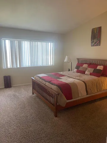 a bedroom with a bed and window