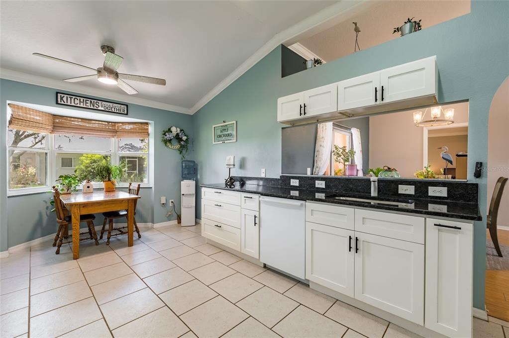9238 Estrella Court New Port Richey, FL 34655 - Photo 14 of 37 a large kitchen with kitchen island a sink table and chairs
