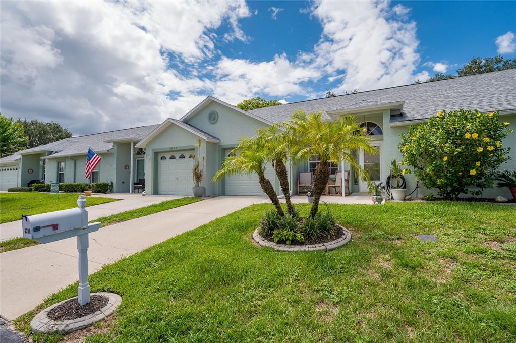 9238 Estrella Court New Port Richey, FL 34655 - Photo 3 of 37 a front view of a house with a yard