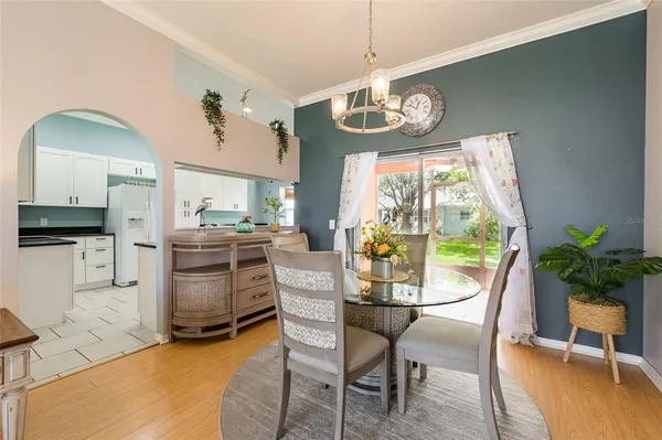 a dining room with furniture a chandelier and window