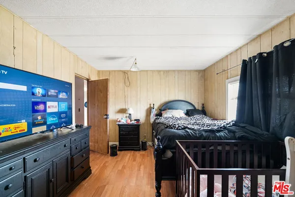 a kitchen with stainless steel appliances kitchen island granite countertop a stove a sink dishwasher and cabinets with wooden floor