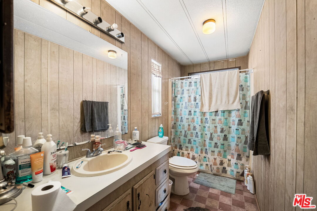4120 La Mesa Road Phelan, CA 92371 - Photo 13 of 30 a bathroom with a sink a toilet and a mirror