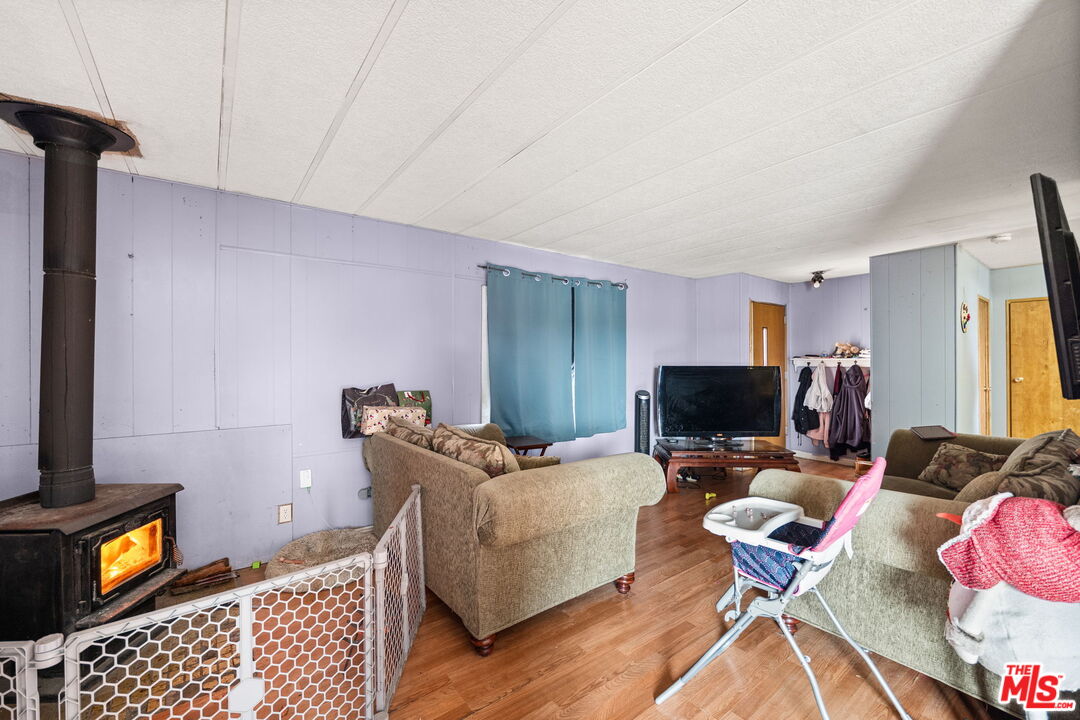 4120 La Mesa Road Phelan, CA 92371 - Photo 6 of 30 a living room with furniture and a flat screen tv