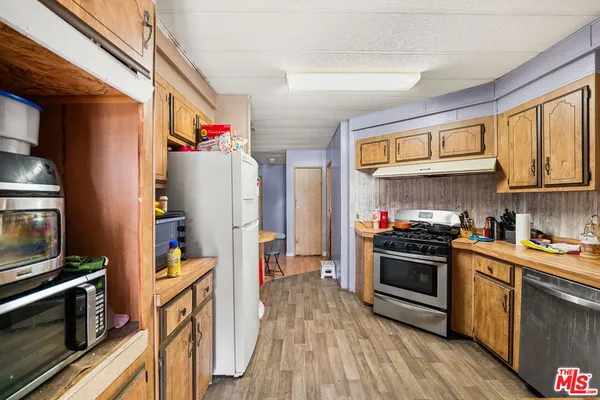 a kitchen with stainless steel appliances granite countertop a stove and a refrigerator