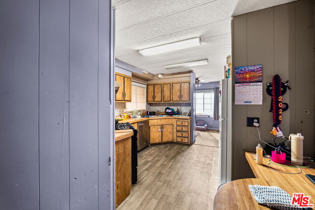 4120 La Mesa Road Phelan, CA 92371 - Photo 9 of 30 a kitchen with stainless steel appliances granite countertop a stove a sink and a refrigerator