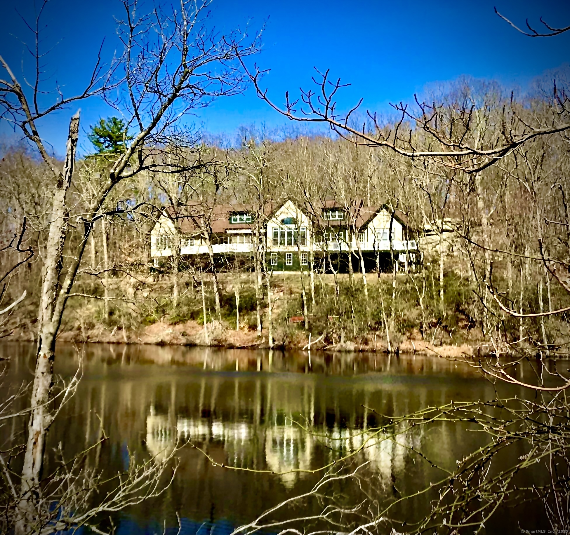 95 Cedar Swamp Road Chester, CT 06412 - Photo 1 of 1 a view of a lake with a building in the background