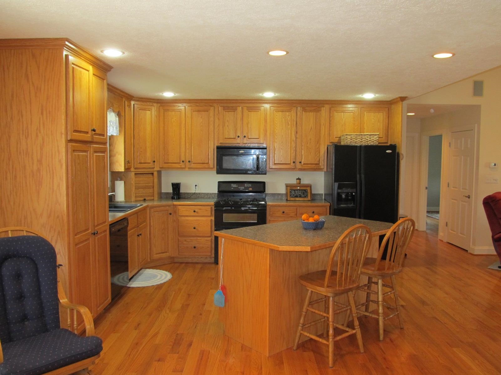 458 St James Road Fishersville, VA 22939 - Photo 9 of 61 a kitchen with stainless steel appliances a refrigerator a stove a sink dishwasher with a dining table and chairs with wooden floor