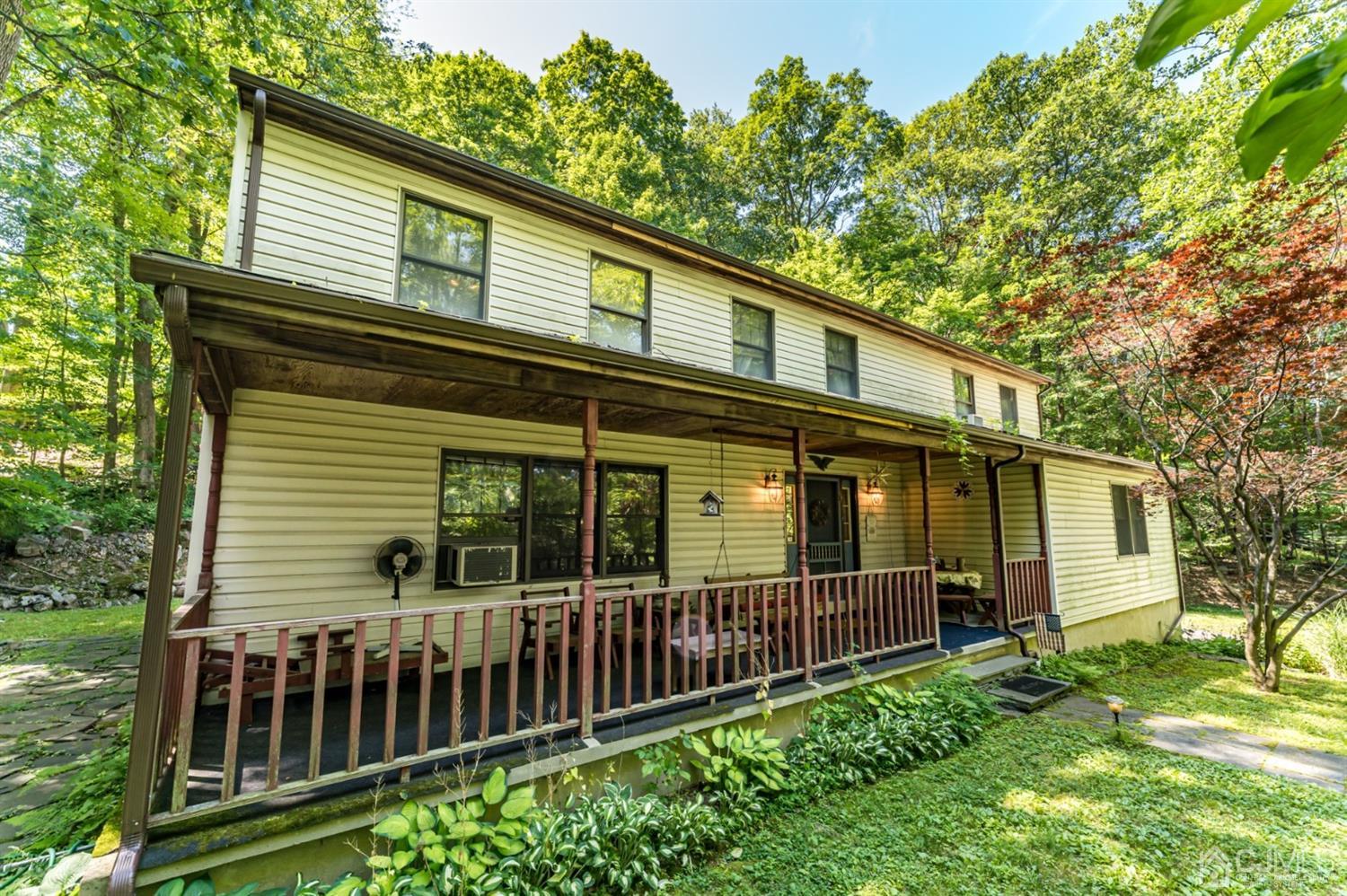 19 Russling Road Hackettstown, NJ 07840 - Photo 1 of 27 a front view of a house with a garden