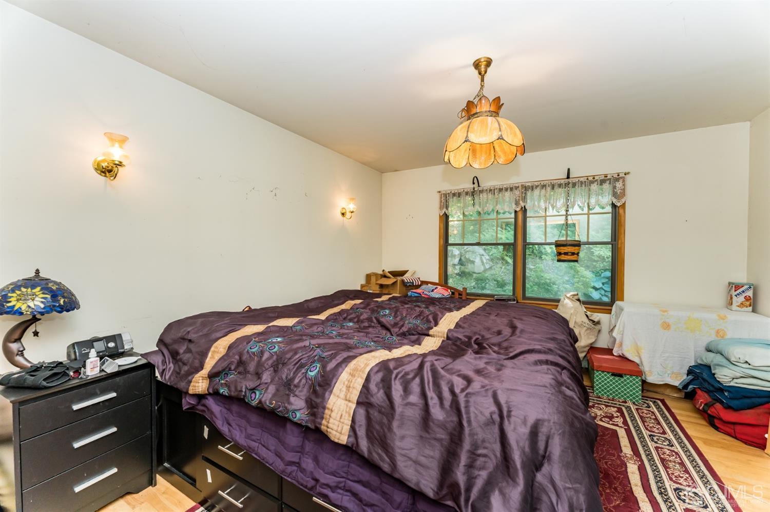 19 Russling Road Hackettstown, NJ 07840 - Photo 12 of 27 a bed sitting in a bedroom next to a window
