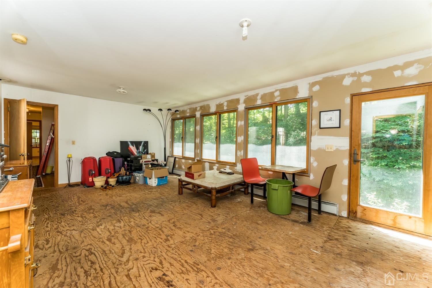19 Russling Road Hackettstown, NJ 07840 - Photo 18 of 27 a living room with furniture and a floor to ceiling window