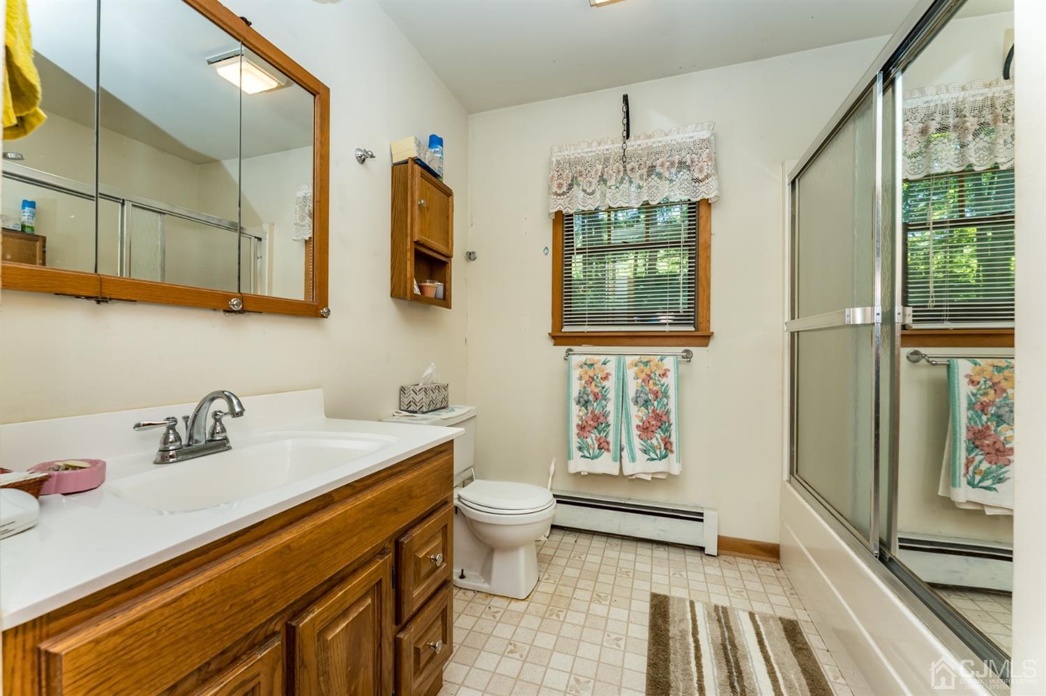 19 Russling Road Hackettstown, NJ 07840 - Photo 24 of 27 a bathroom with a sink a toilet and mirror