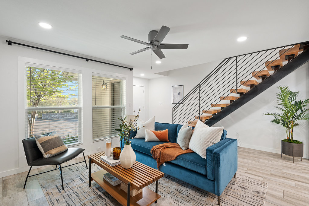 a living room with furniture and wooden floor
