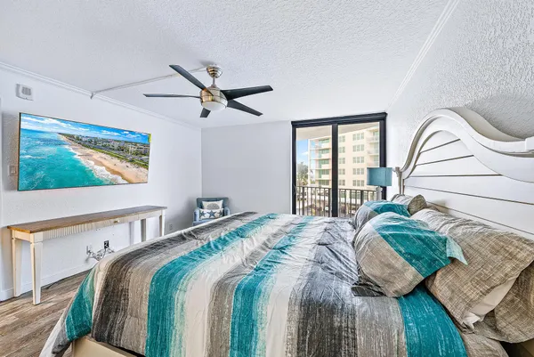 a bedroom with a bed a window and a dresser