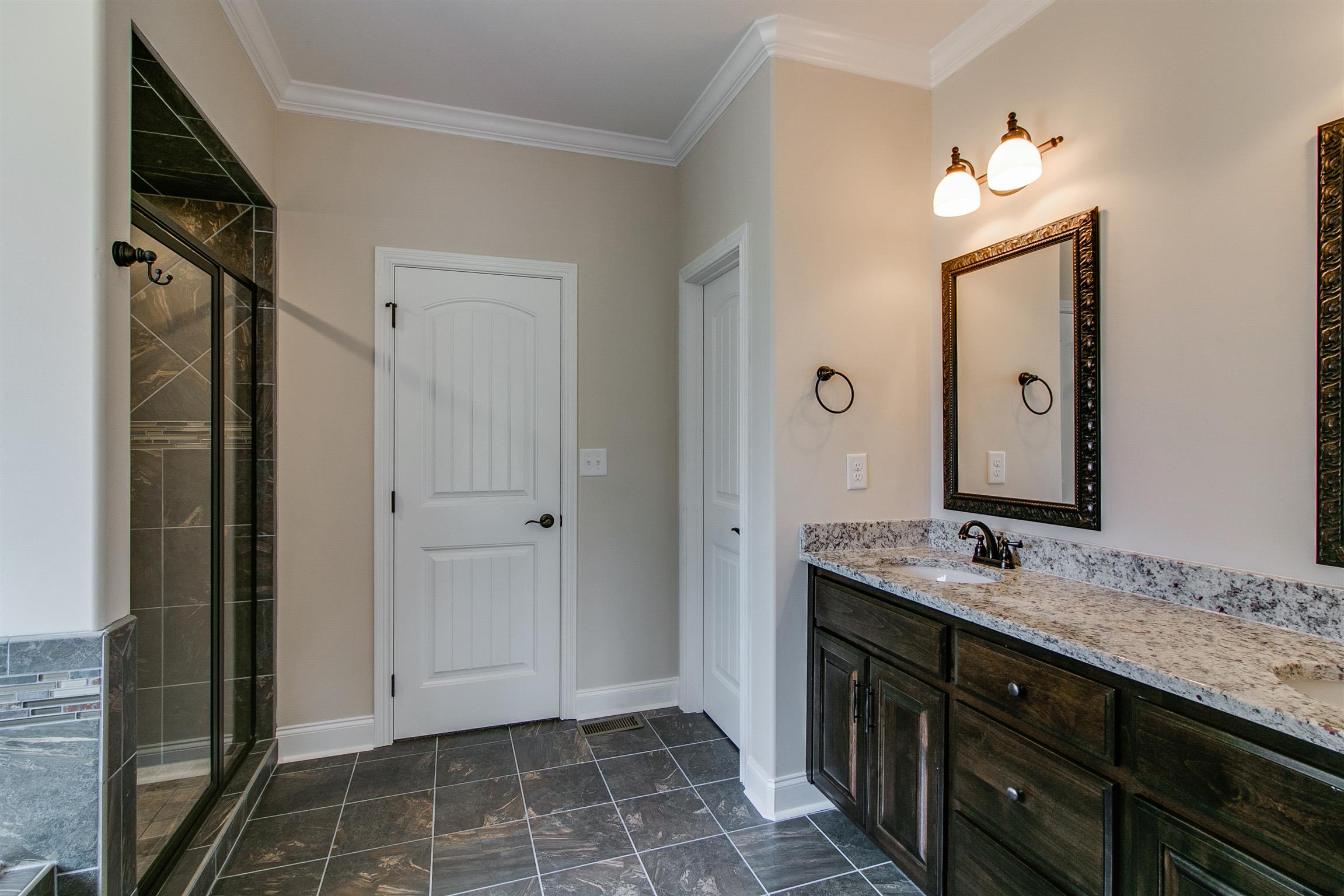 3548 Drake Road Adams, TN 37010 - Photo 18 of 30 a bathroom with a double vanity sink mirror and shower