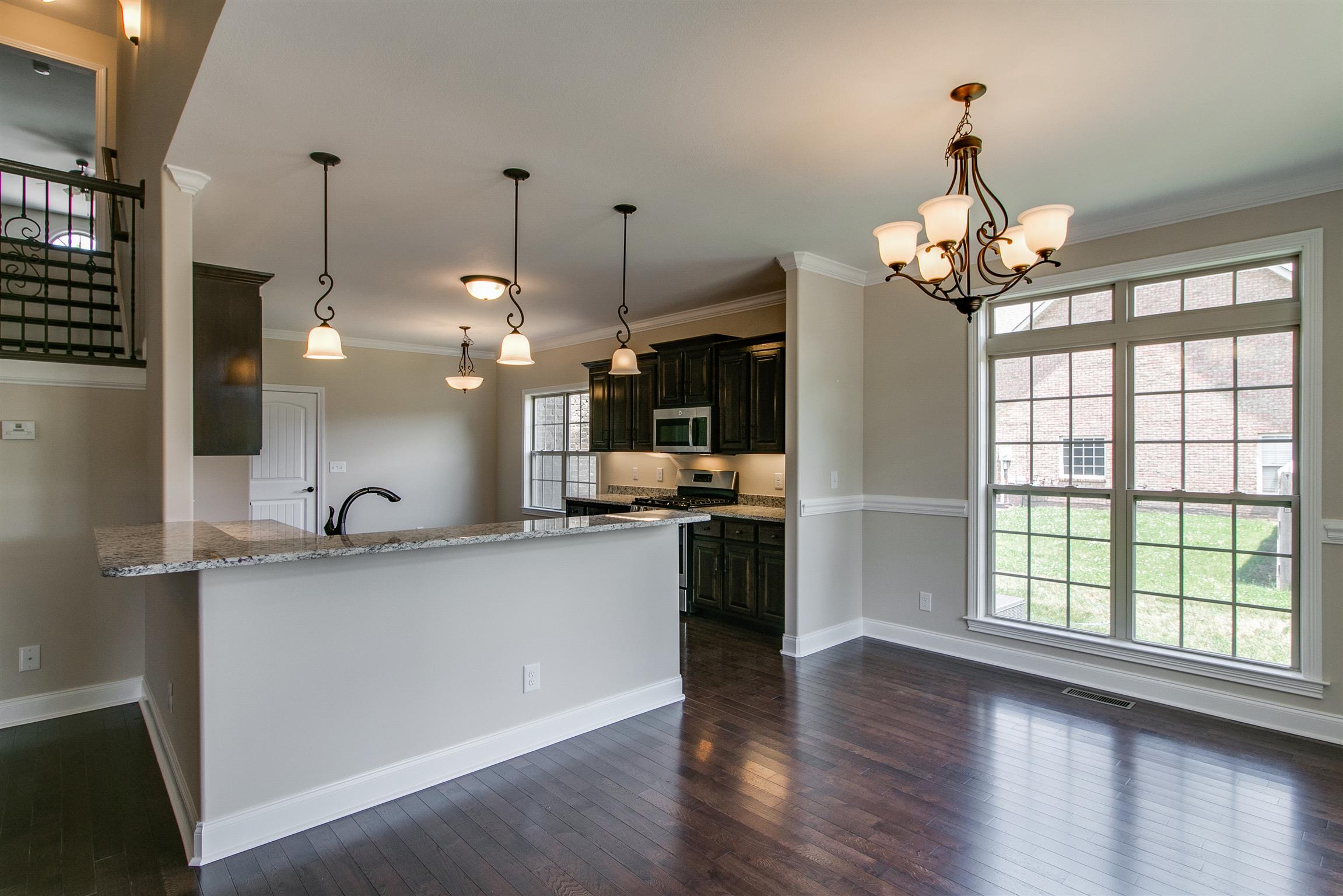 3548 Drake Road Adams, TN 37010 - Photo 7 of 30 a kitchen with kitchen island granite countertop a stove a sink a center island a refrigerator and a wooden floor