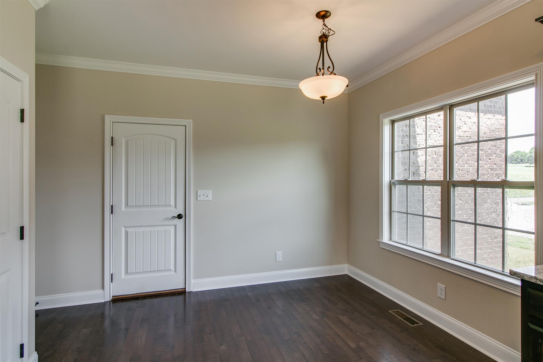 3548 Drake Road Adams, TN 37010 - Photo 10 of 30 a view of an empty room with wooden floor and a window