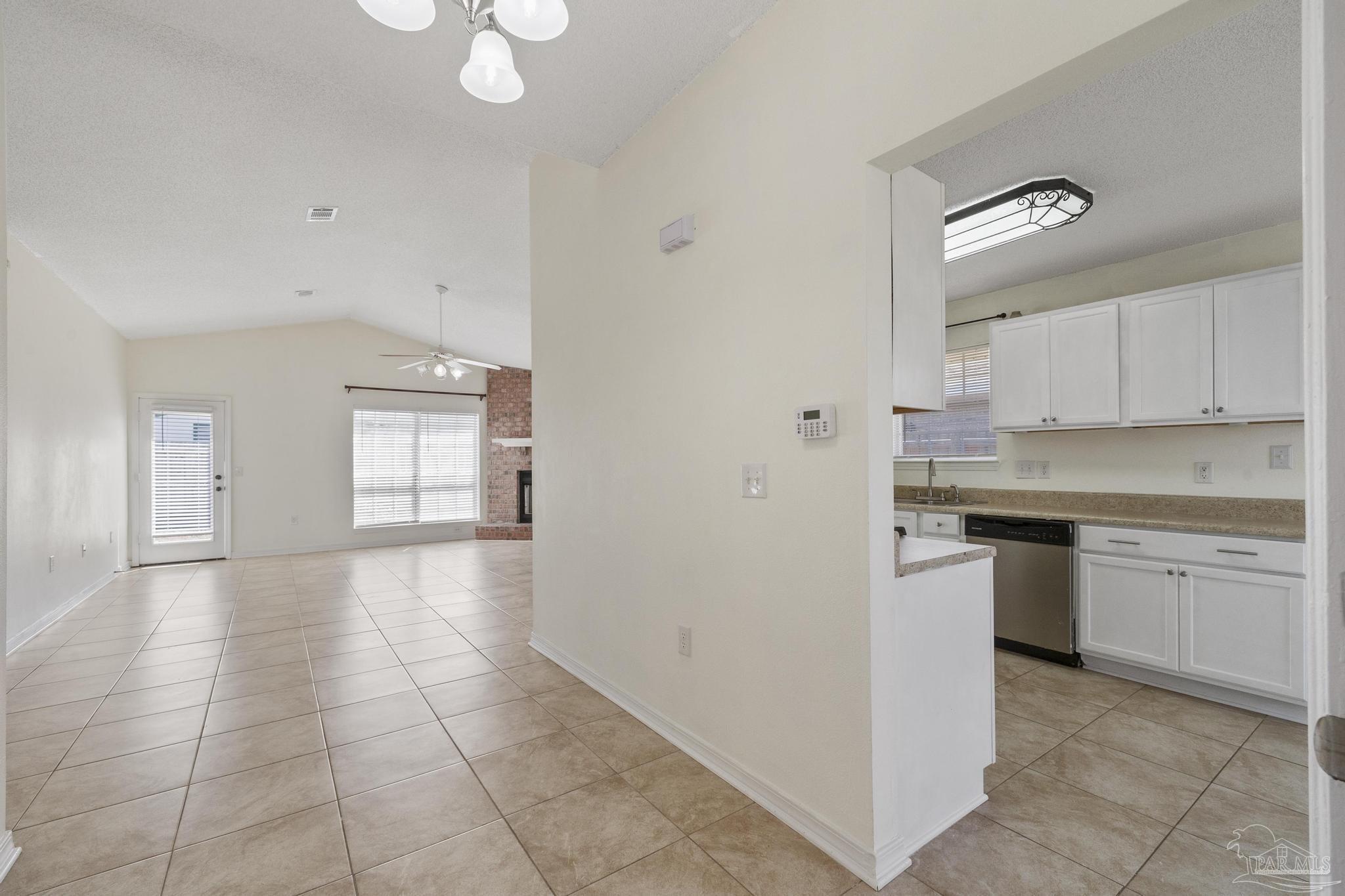4769 Ribault Lane Milton, FL 32570 - Photo 12 of 34 a kitchen with a stove a sink and a refrigerator