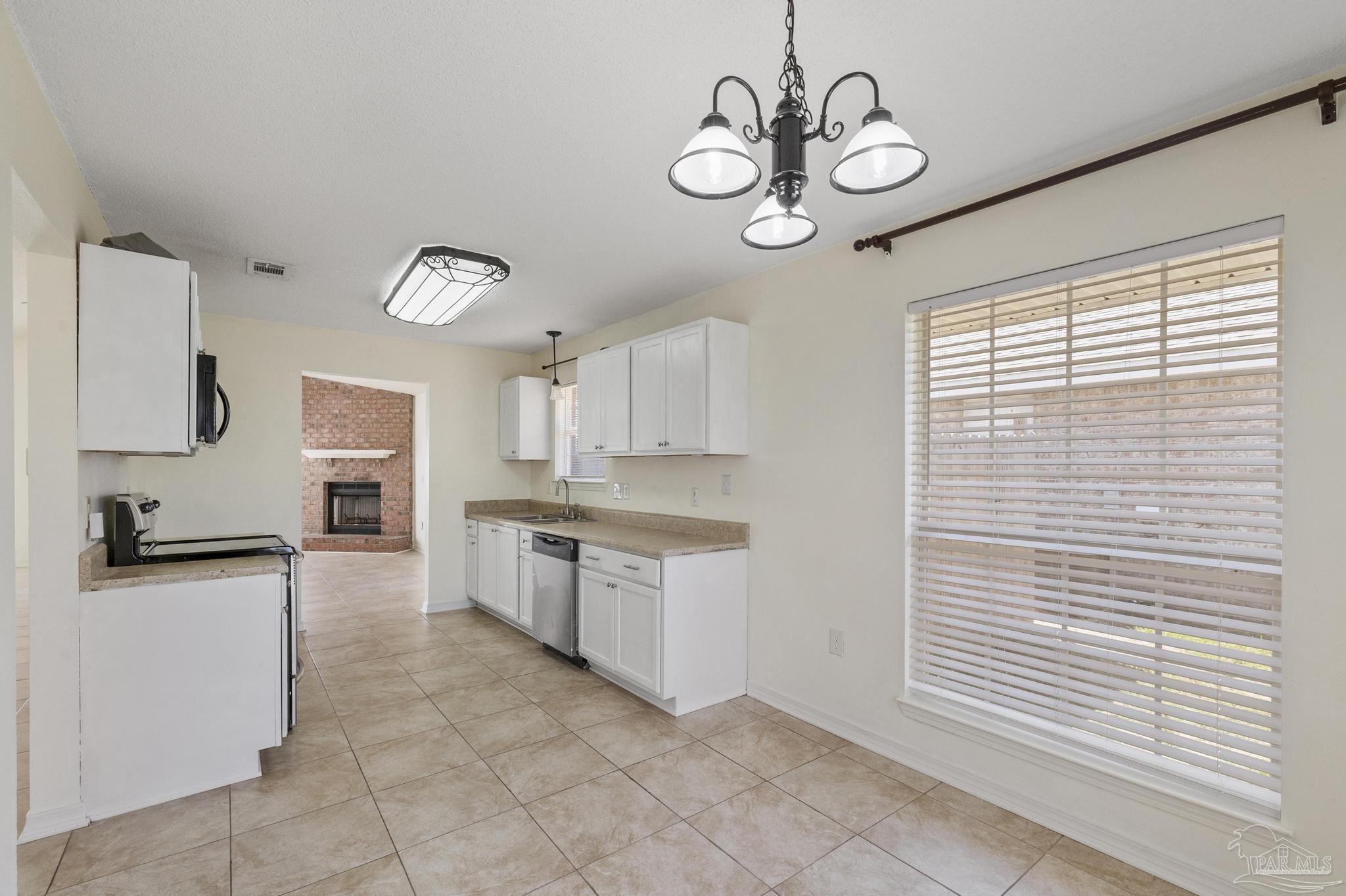 4769 Ribault Lane Milton, FL 32570 - Photo 16 of 34 a open kitchen with a sink stainless steel appliances and cabinets