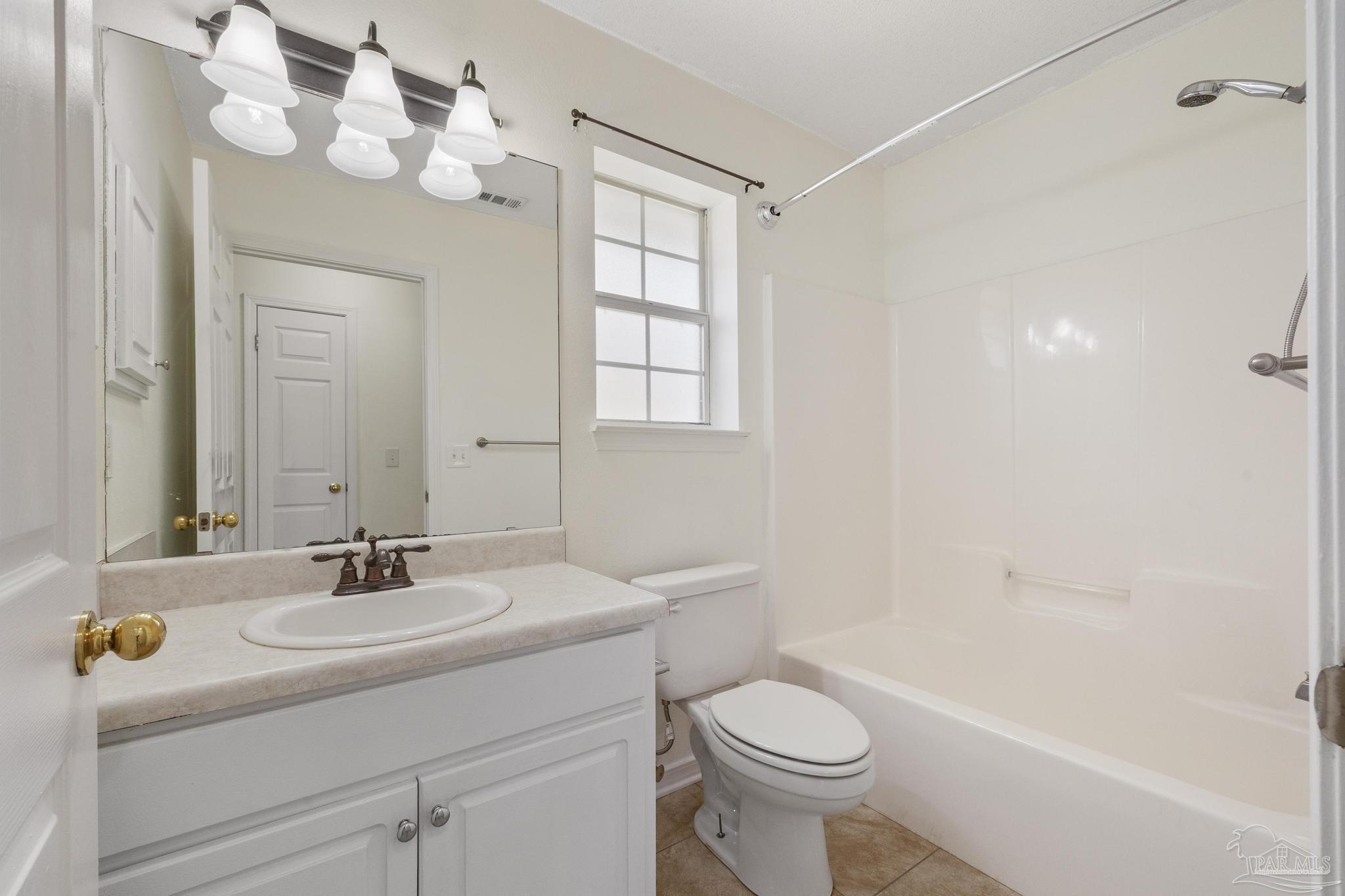 4769 Ribault Lane Milton, FL 32570 - Photo 23 of 34 a bathroom with a sink a toilet and a mirror