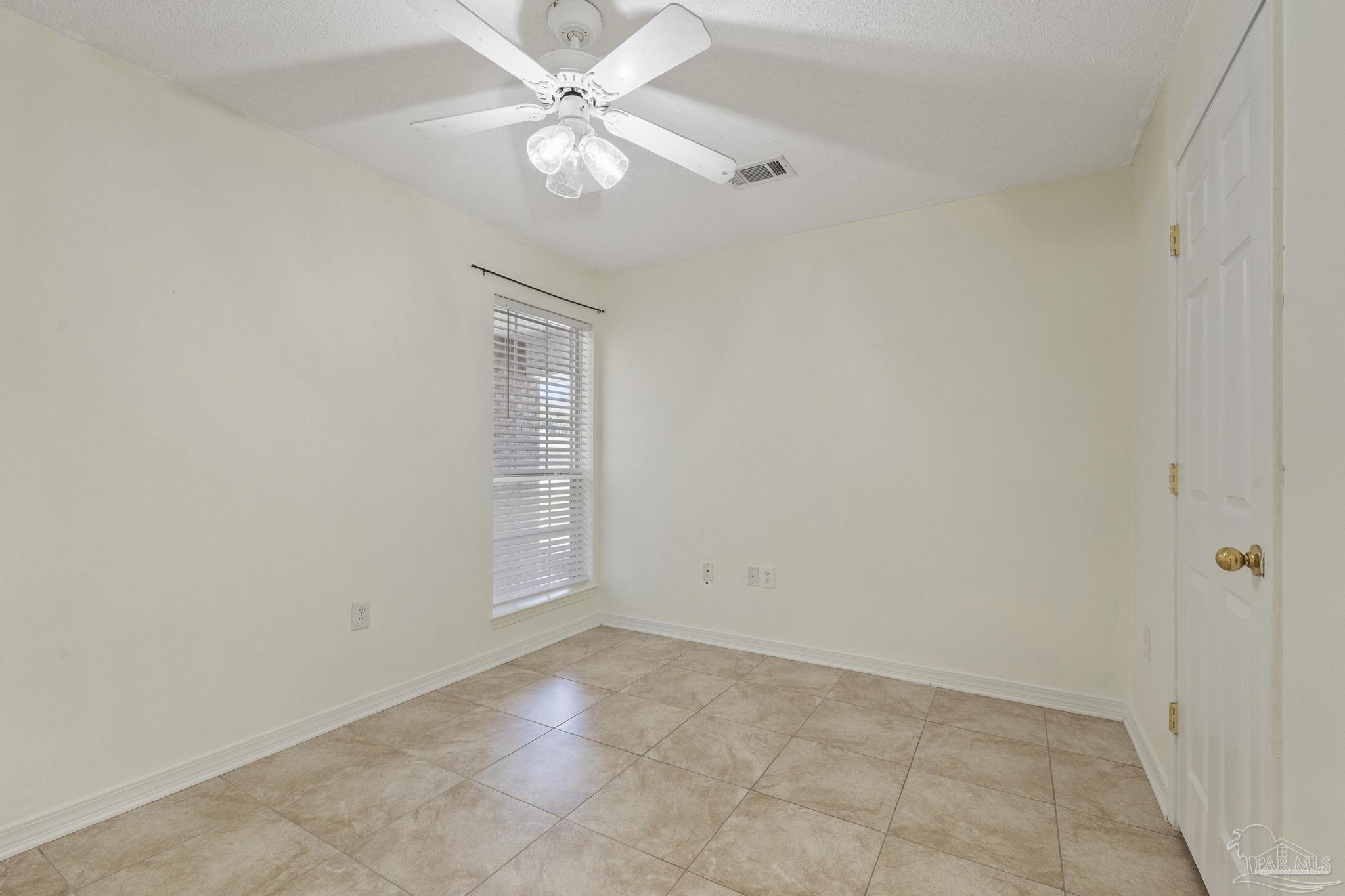 4769 Ribault Lane Milton, FL 32570 - Photo 24 of 34 an empty room with a window and ceiling fan