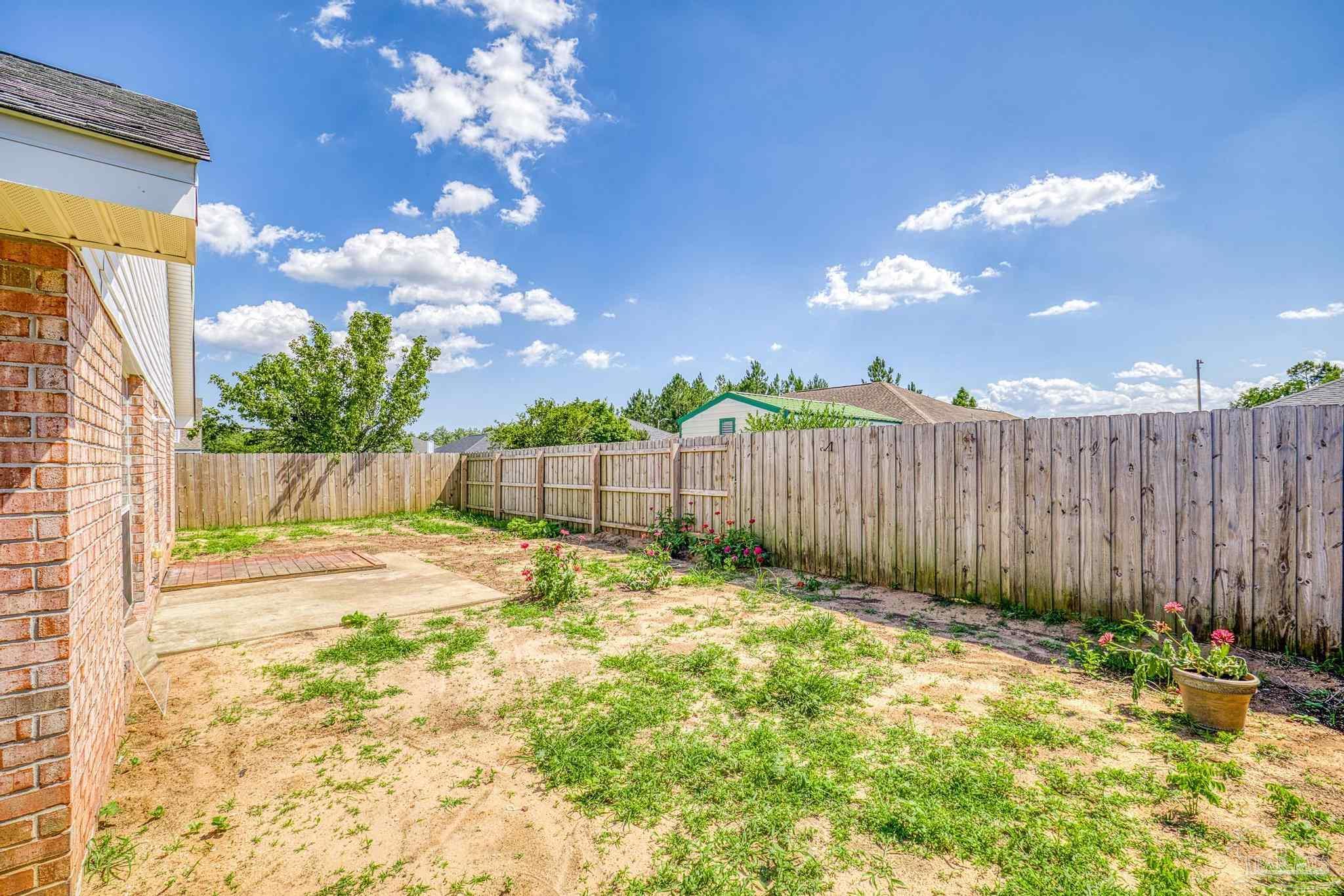 4769 Ribault Lane Milton, FL 32570 - Photo 27 of 34 a view of backyard with wooden fence