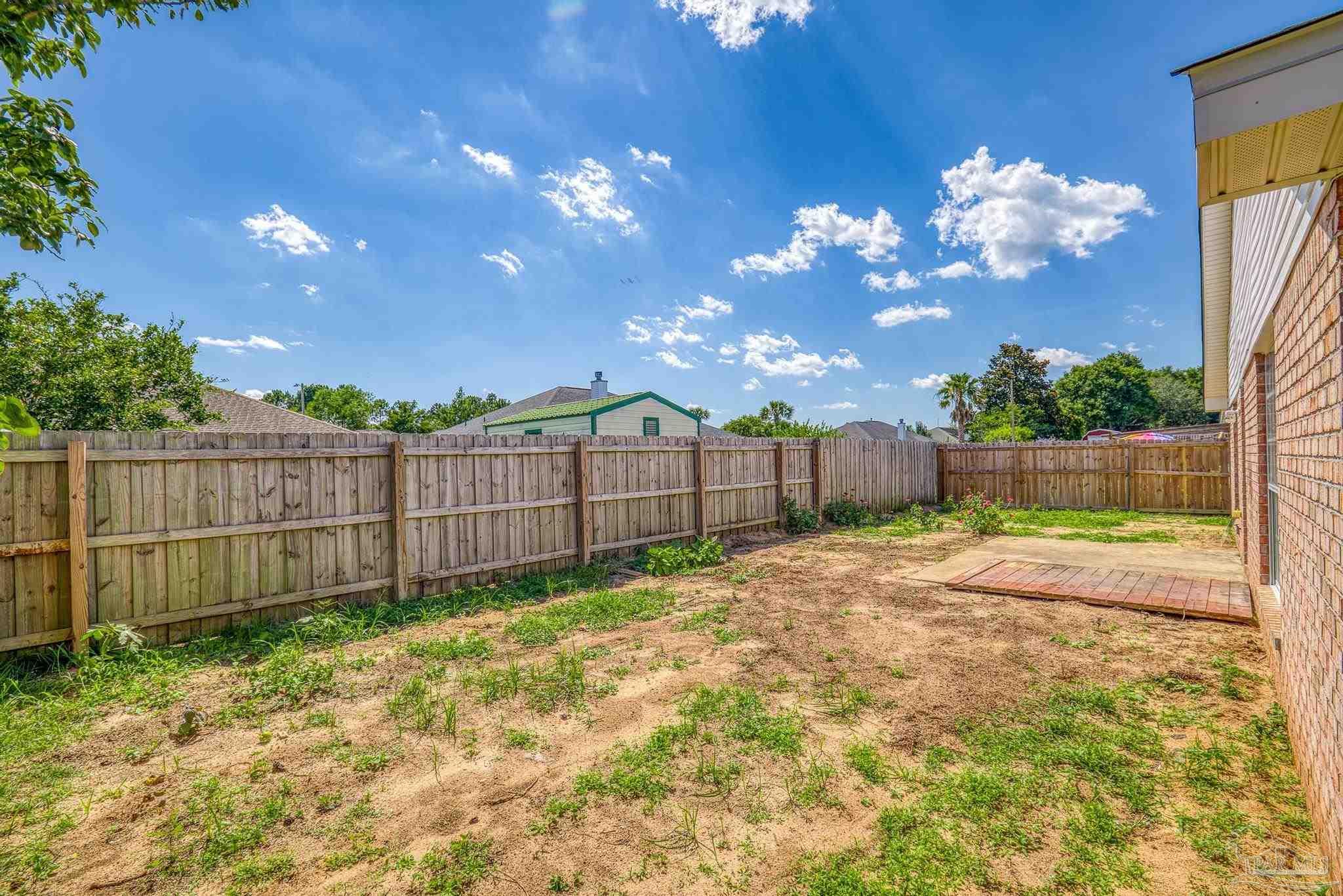 4769 Ribault Lane Milton, FL 32570 - Photo 28 of 34 a view of a backyard with wooden fence
