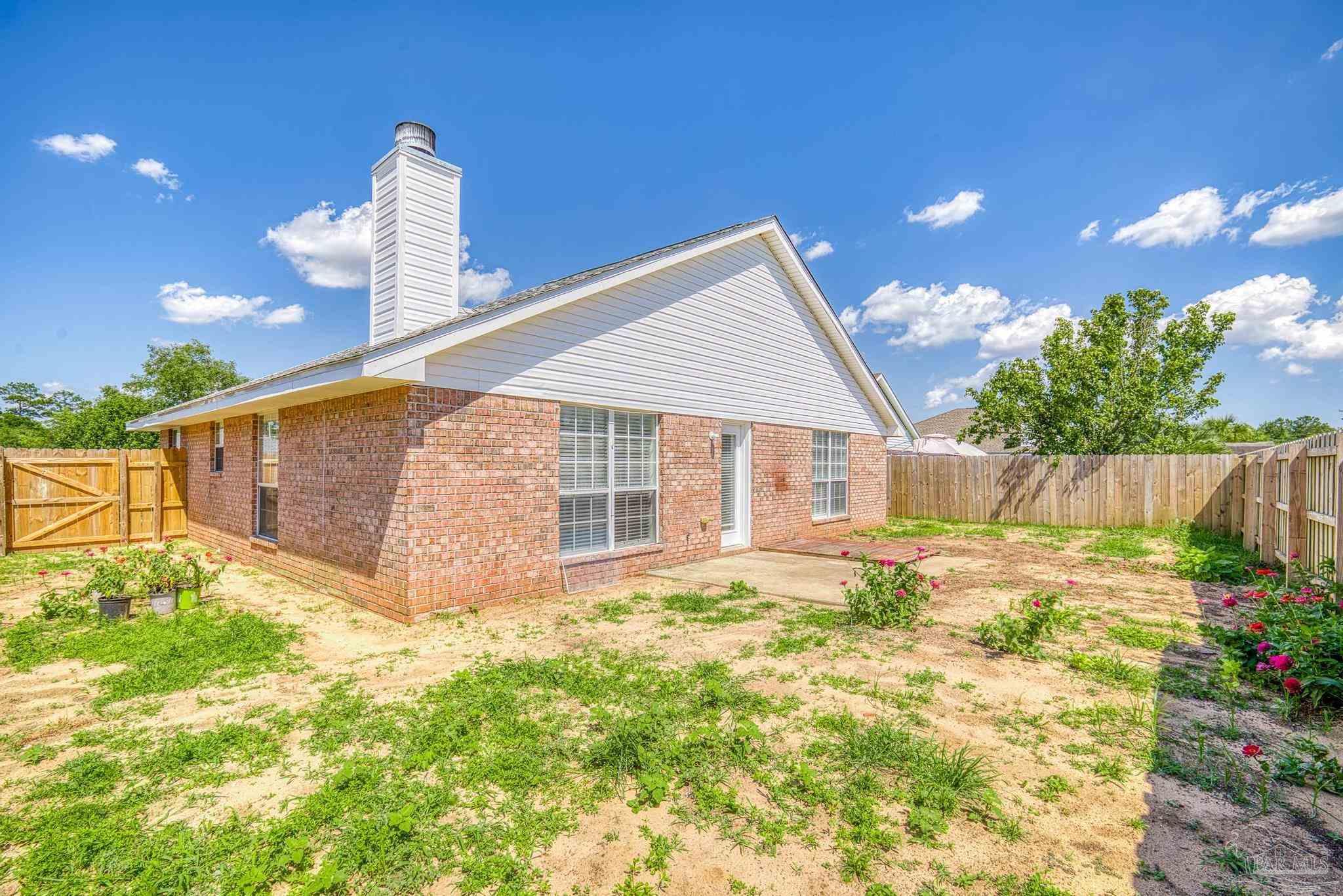 4769 Ribault Lane Milton, FL 32570 - Photo 29 of 34 a view of a house with backyard and sitting area