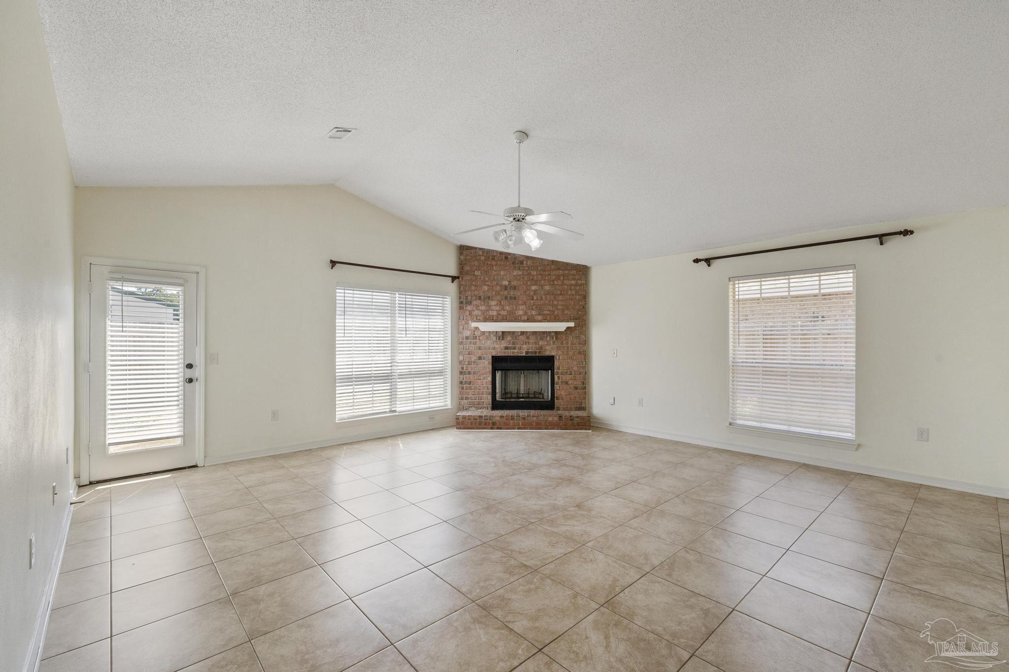 4769 Ribault Lane Milton, FL 32570 - Photo 3 of 34 an empty room with windows and fireplace