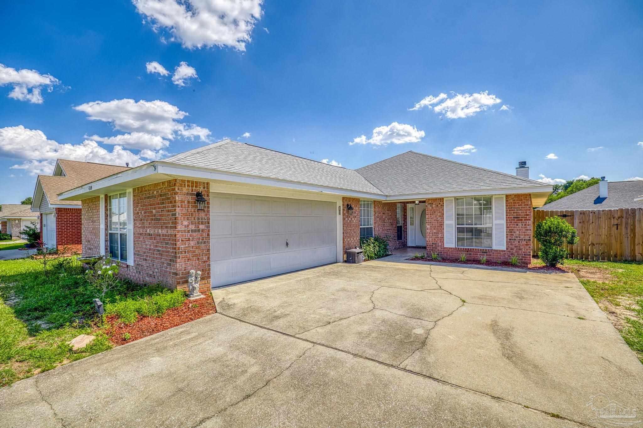 4769 Ribault Lane Milton, FL 32570 - Photo 7 of 34 a view of a house with a yard and potted plants
