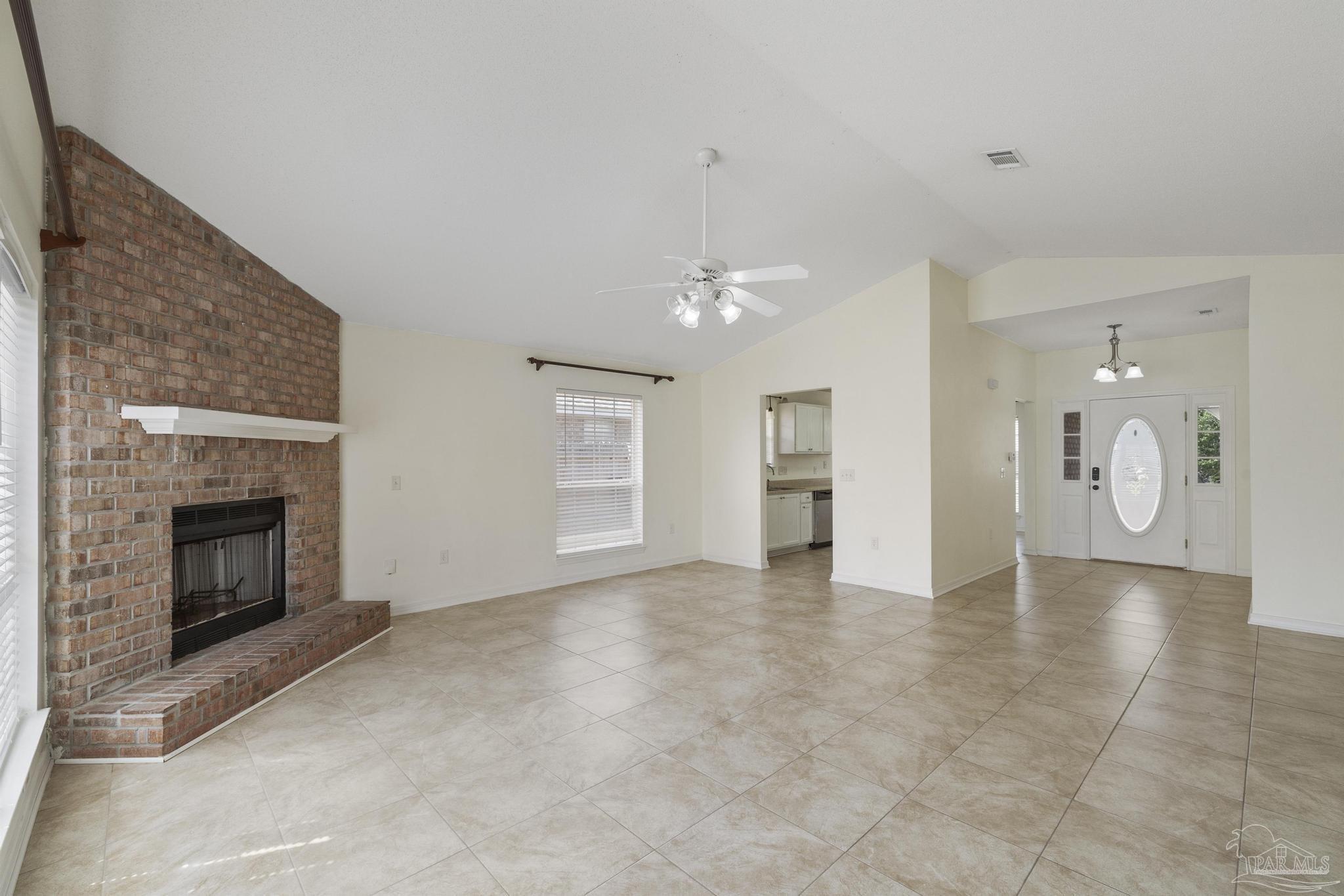 4769 Ribault Lane Milton, FL 32570 - Photo 10 of 34 a view of an empty room with a fireplace and window