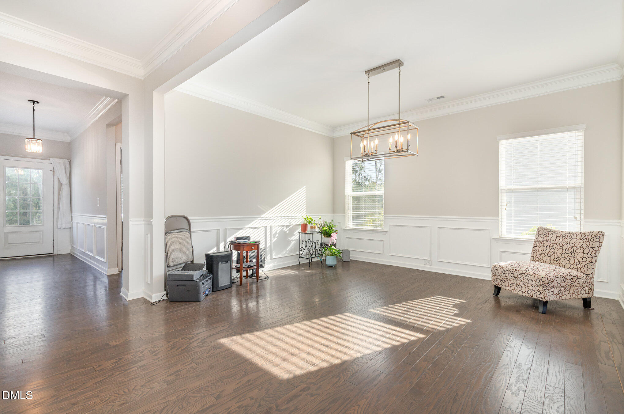 187 Highland Rhodes Drive Clayton, NC 27520 - Photo 10 of 23 a living room with furniture and a chandelier