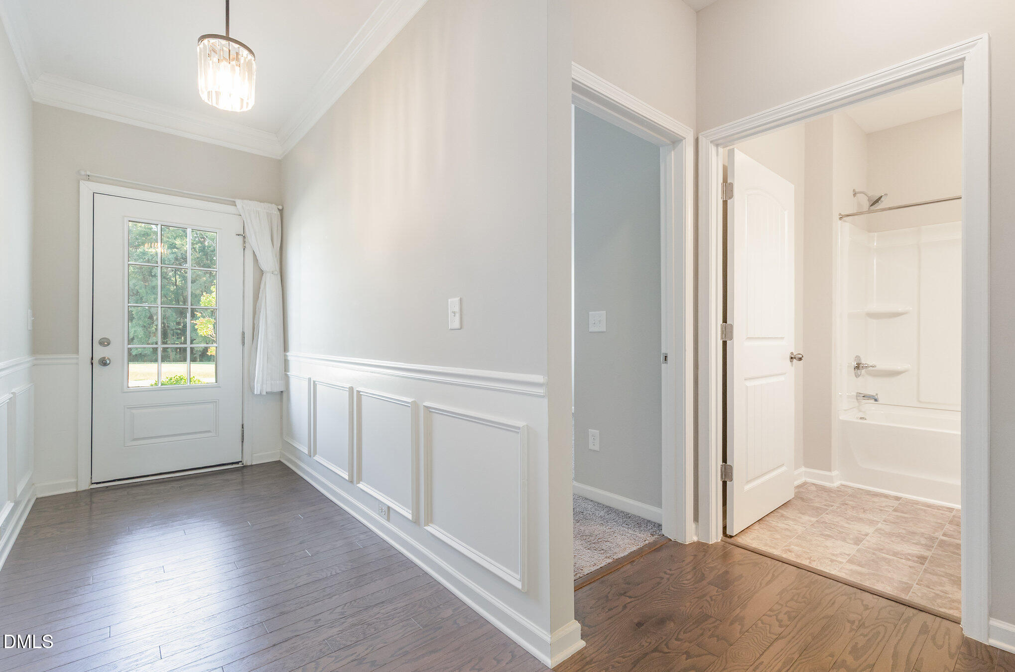 187 Highland Rhodes Drive Clayton, NC 27520 - Photo 3 of 23 an empty room with wooden floor and windows