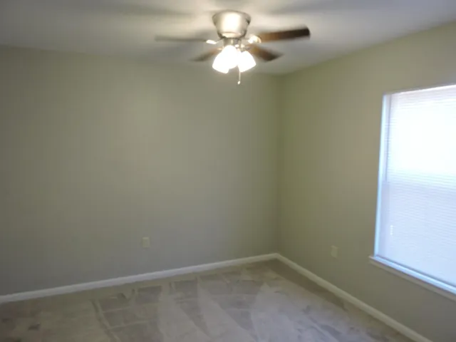 a view of a small space with wooden floor and a chandelier fan