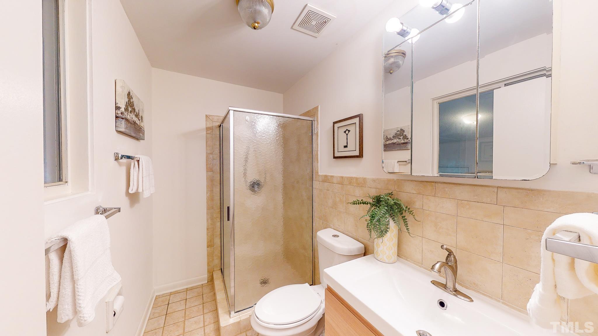 4405 Laurel Hills Road Raleigh, NC 27612 - Photo 22 of 29 a bathroom with a sink toilet and shower
