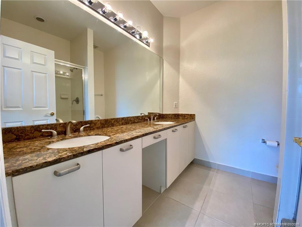 59 Southeast Palermo, Unit 102 Stuart, FL 34994 - Photo 14 of 18 a bathroom with a sink and a mirror