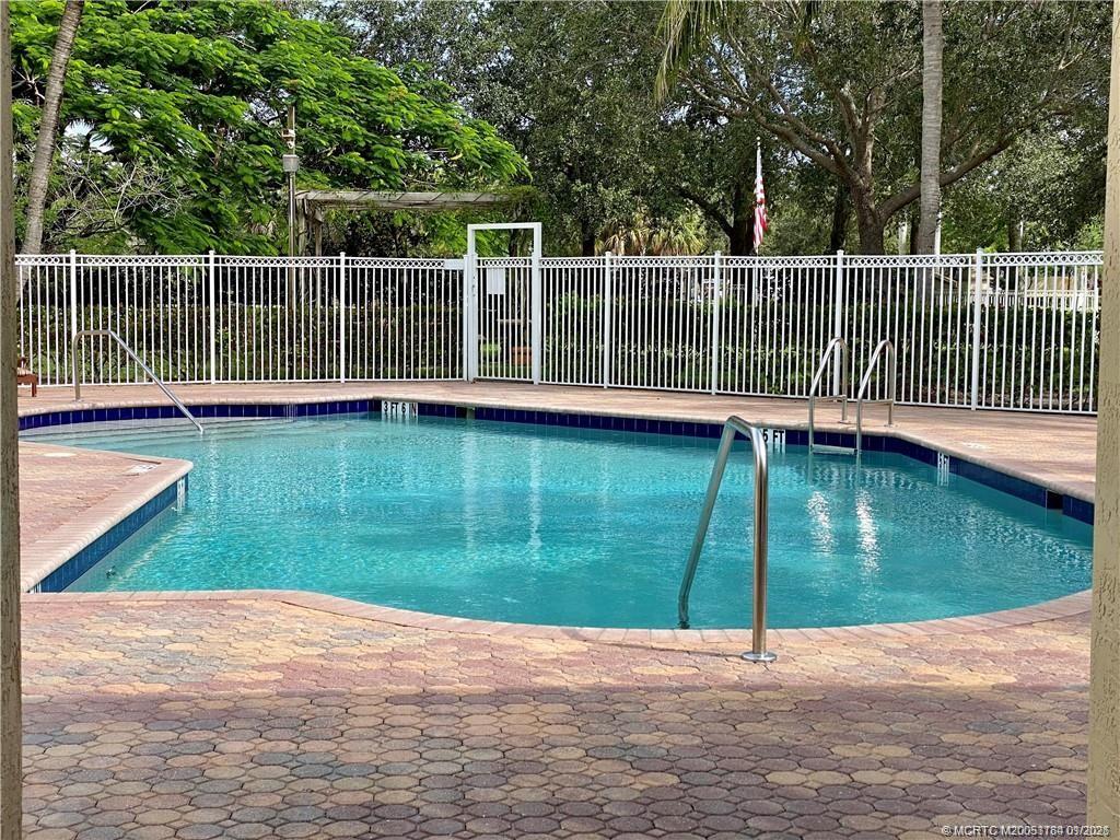 59 Southeast Palermo, Unit 102 Stuart, FL 34994 - Photo 17 of 18 a view of a garden with a bench