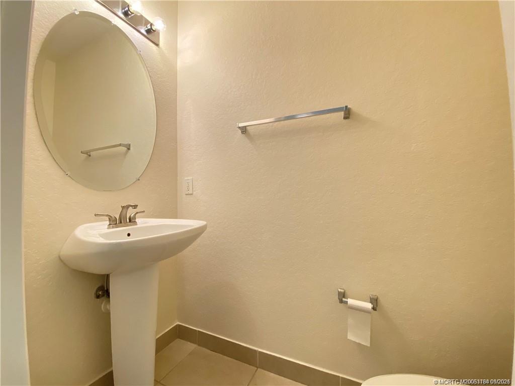 59 Southeast Palermo, Unit 102 Stuart, FL 34994 - Photo 8 of 18 a bathroom with a sink and mirror