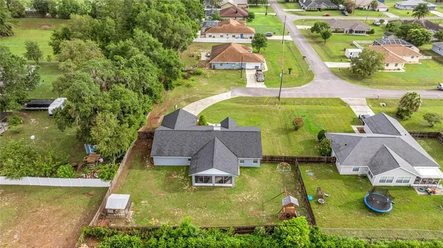 an aerial view of residential houses with outdoor space and swimming pool