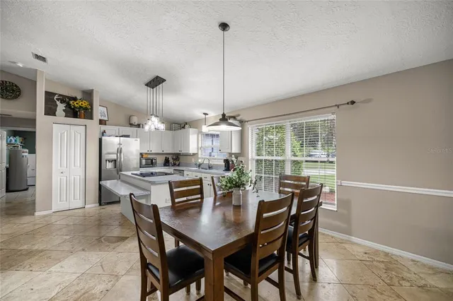 a dining room with furniture a chandelier and a rug