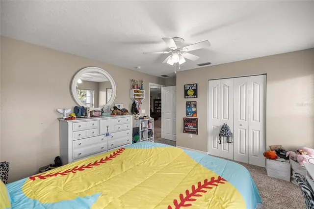 a bed room with a bed and a mirror