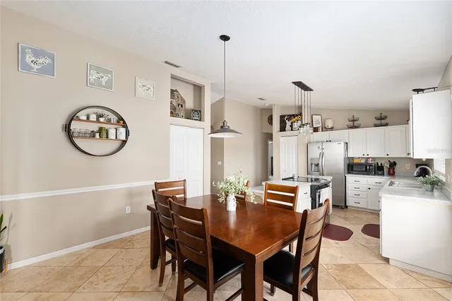 a view of a dining room with furniture and a clock