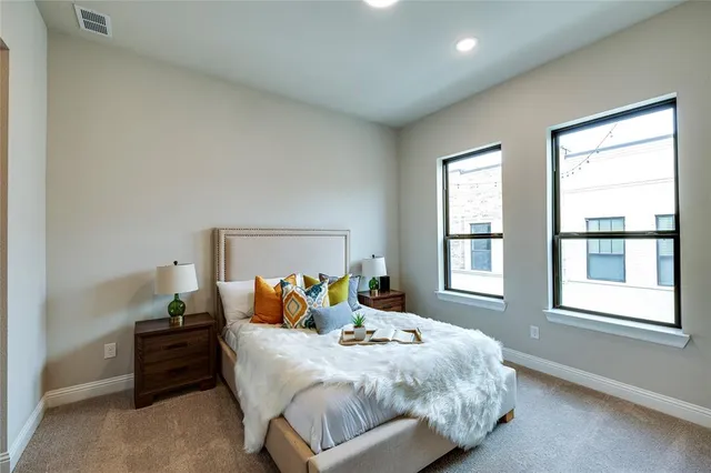 a bed sitting in a bedroom next to a window