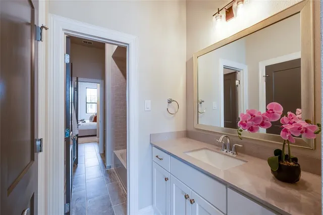 a bathroom with a sink vanity and mirror