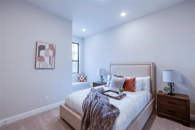 a bedroom with a bed and a lamp