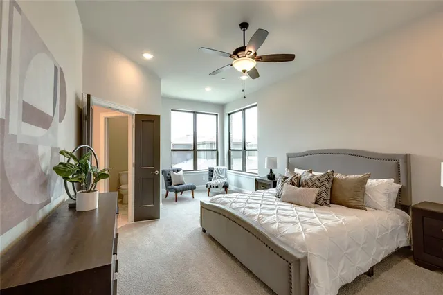 a bedroom with a large bed and a chandelier