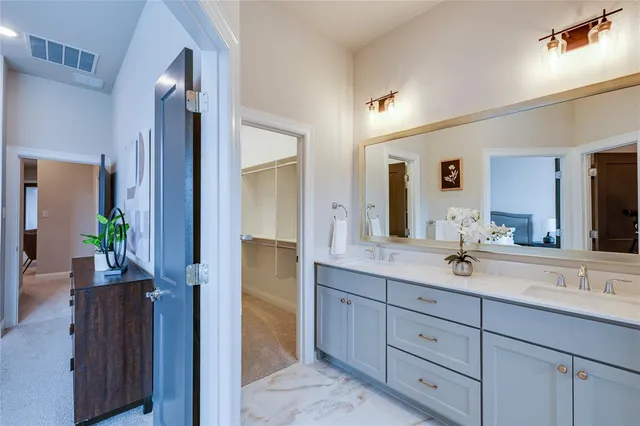 a spacious bathroom with a granite countertop sink and a mirror