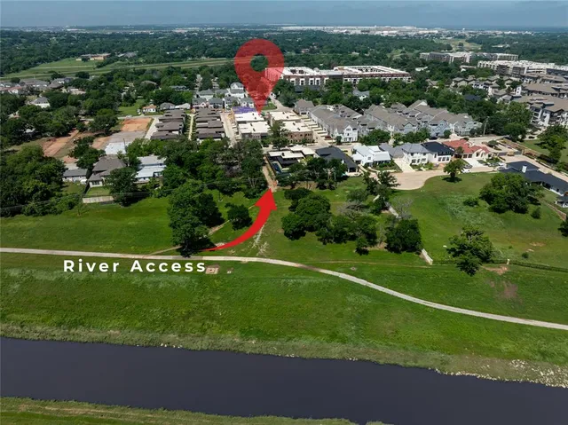an aerial view of residential houses with outdoor space and street view