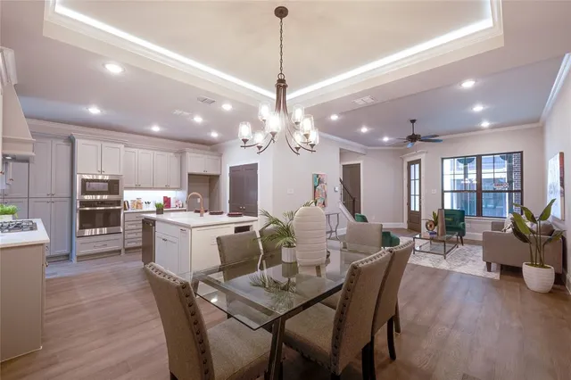 a large kitchen with a table and chairs
