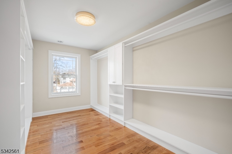118 Cambridge Road Westfield, NJ 07090 - Photo 22 of 50 a view of an empty room with a window and wooden floor