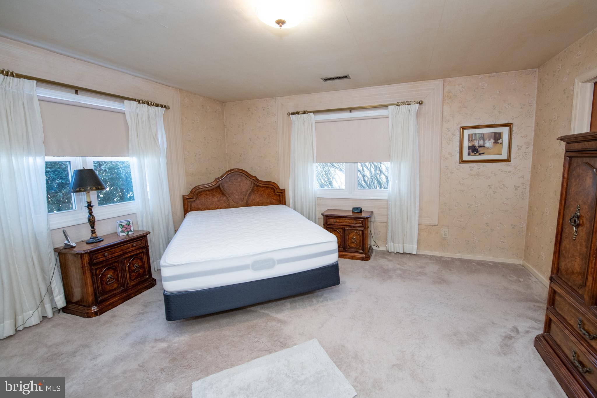 8810 Tyson Road Glenside, PA 19038 - Photo 18 of 53 a bedroom with a bed and a lamp on dresser